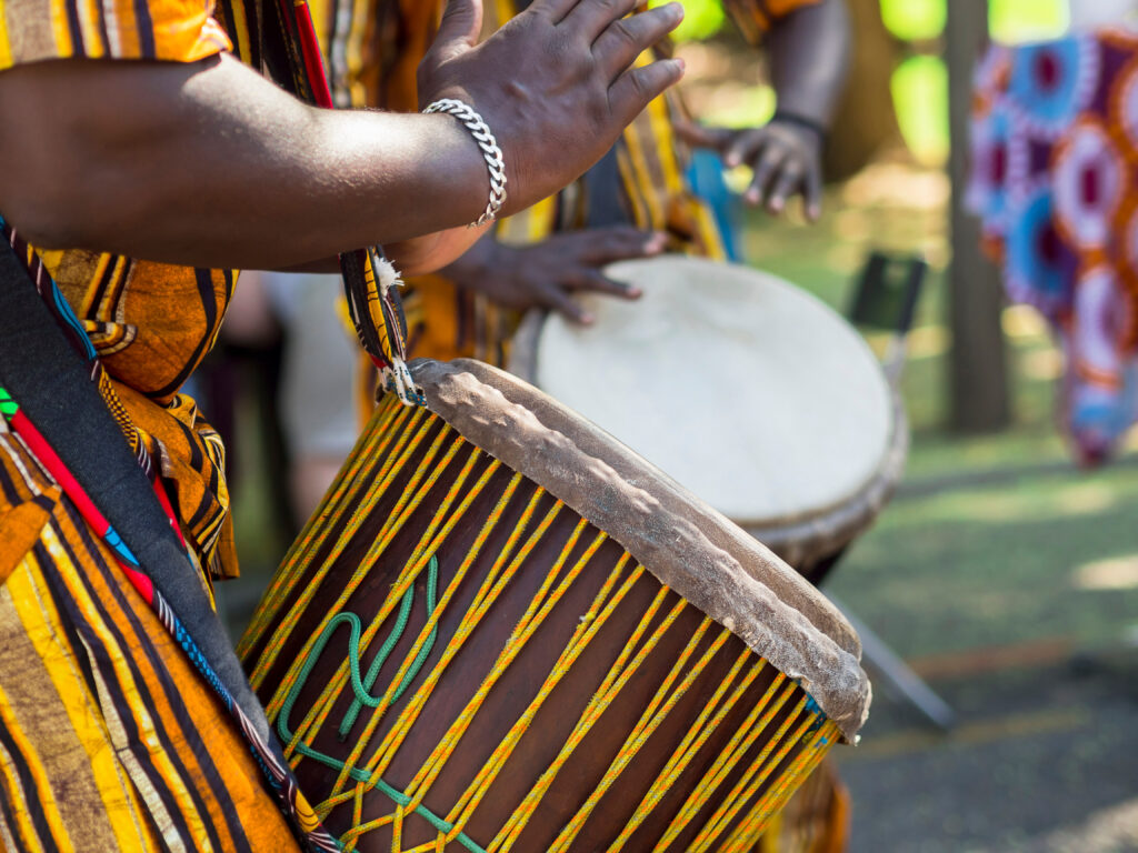 African man's hands playing the African drum. African tradition and musical culture.